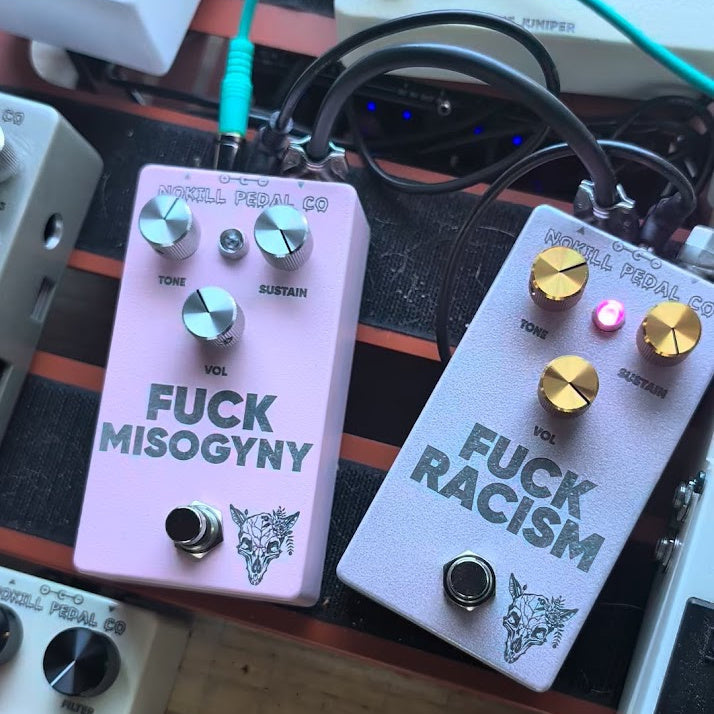 The FUCK MISOGYNY and FUCK RACISM pedals side by side on a pedalboard.